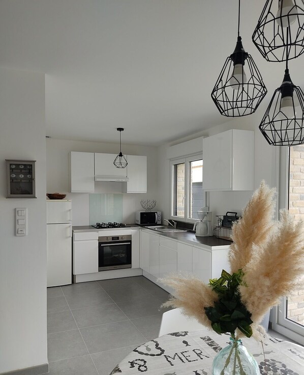 Enjoy cooking in this well-equipped kitchen with a gas stove, microwave, and coffee machine.