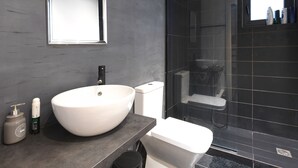 A modern bathroom with a large white sink, a mirror, and a shower area. - Imvrou25-200Mb fibre remote workers' Dreamhouse (Athens)