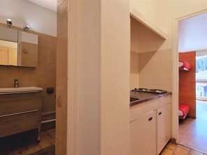 A compact kitchen with a sink, stove, and cabinets. - Studio for 4 near slopes, parking, WiFi, pets allowed (Le Dévoluy)