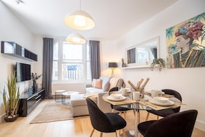 Grand Apartment, 3 Bedrooms, City View | Living area | Flat-screen TV