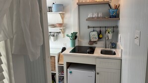 A compact kitchen with a built-in dishwasher, a sink, and a countertop. - Charming 2-bedroom cottage in Old Orchard Beach, perfect for family getaways. (Old Orchard Beach)