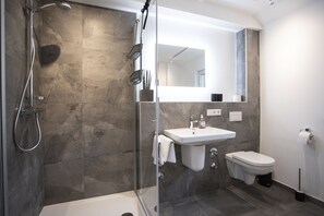 Shower, hair dryer, towels, toilet paper