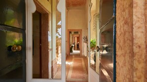 A corridor with a wooden door, a glass door, and a view into a room with a bed and a window. - Villa Torre di Terzolan With Pool and Jacuzzi (Verona)