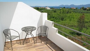 A balcony with two chairs and a small table, overlooking a green landscape and distant mountains. - A1 - Modern apt With Balcony, sea View & Parking (Sucuraj)