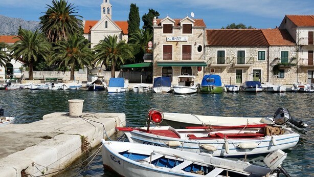 A marina with several boats docked, a church with a bell tower, and traditional stone buildings with balconies. - A1 - Modern apt With Balcony, sea View & Parking (Sucuraj)