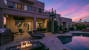 A modern house with a pool, outdoor seating, and a fire pit. - Luxury Contemporary Sanctuary w/ Pool and Views! (Fountain Hills)