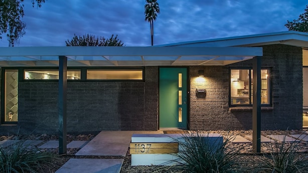 A modern house with a green door, a visible number 1137, and a well-lit interior visible through the windows. - Mid-century Modern W/backyard Oasis, Putting Green (Phoenix)