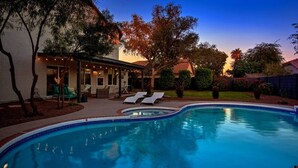 A swimming pool with lounge chairs, a covered patio area, and a well-maintained garden. - Scottsdale Kierland 4 Bdrm W/resort Like Backyard (Scottsdale)