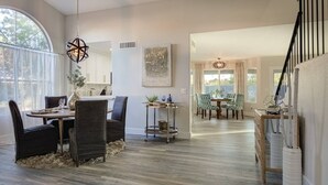 A spacious dining area with a round table, dark chairs, and a hanging light fixture. - Scottsdale Kierland 4 Bdrm W/resort Like Backyard (Scottsdale)