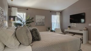 A bedroom with a large bed, a desk, a TV, and decorative plants. - Scottsdale Kierland 4 Bdrm W/resort Like Backyard (Scottsdale)
