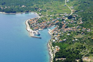 An aerial view of a coastal town with a marina, houses, and green fields. - A2 - Modern apt With Balcony, sea View & Parking (Sucuraj)
