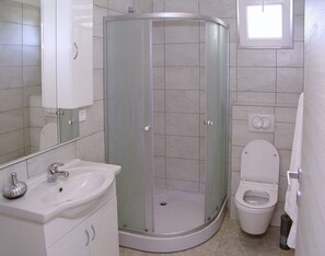 A bathroom with a glass-enclosed shower, a sink, and a toilet. - A2 - Modern apt With Balcony, sea View & Parking (Sucuraj)