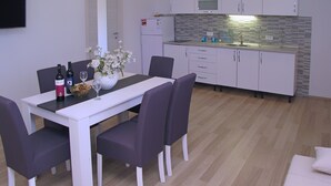 A modern kitchen with white cabinets, a built-in microwave, and a tiled backsplash. - A2 - Modern apt With Balcony, sea View & Parking (Sucuraj)