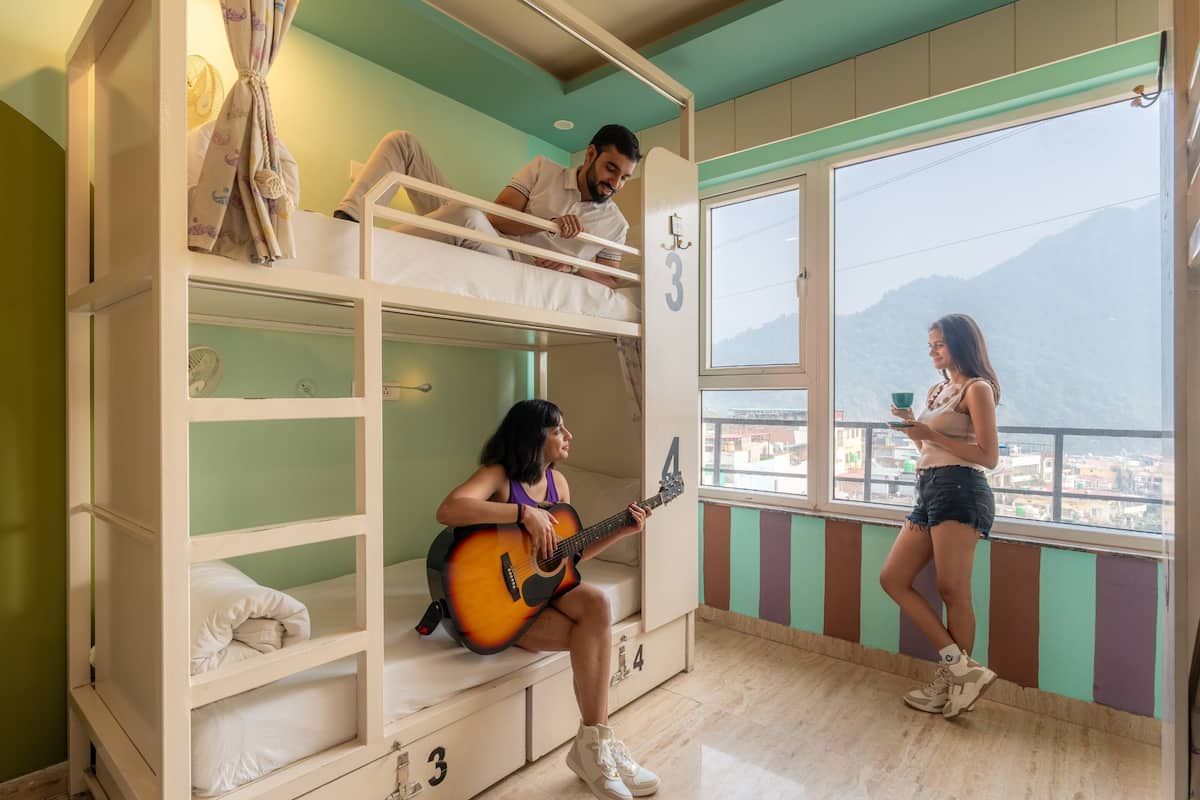 A bunk bed room with a view of a mountain.