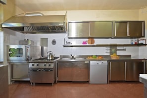 A commercial kitchen with stainless steel appliances, including a stove, oven, and dishwasher.