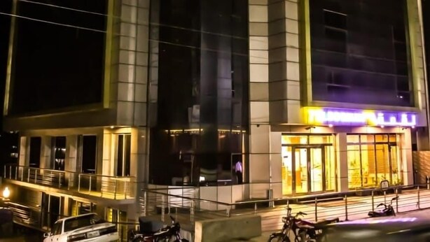 A modern hotel with a prominent 'MARIANHOTEL' sign, large windows, and a well-lit entrance. - Marjan Hotel (Rawalakot)