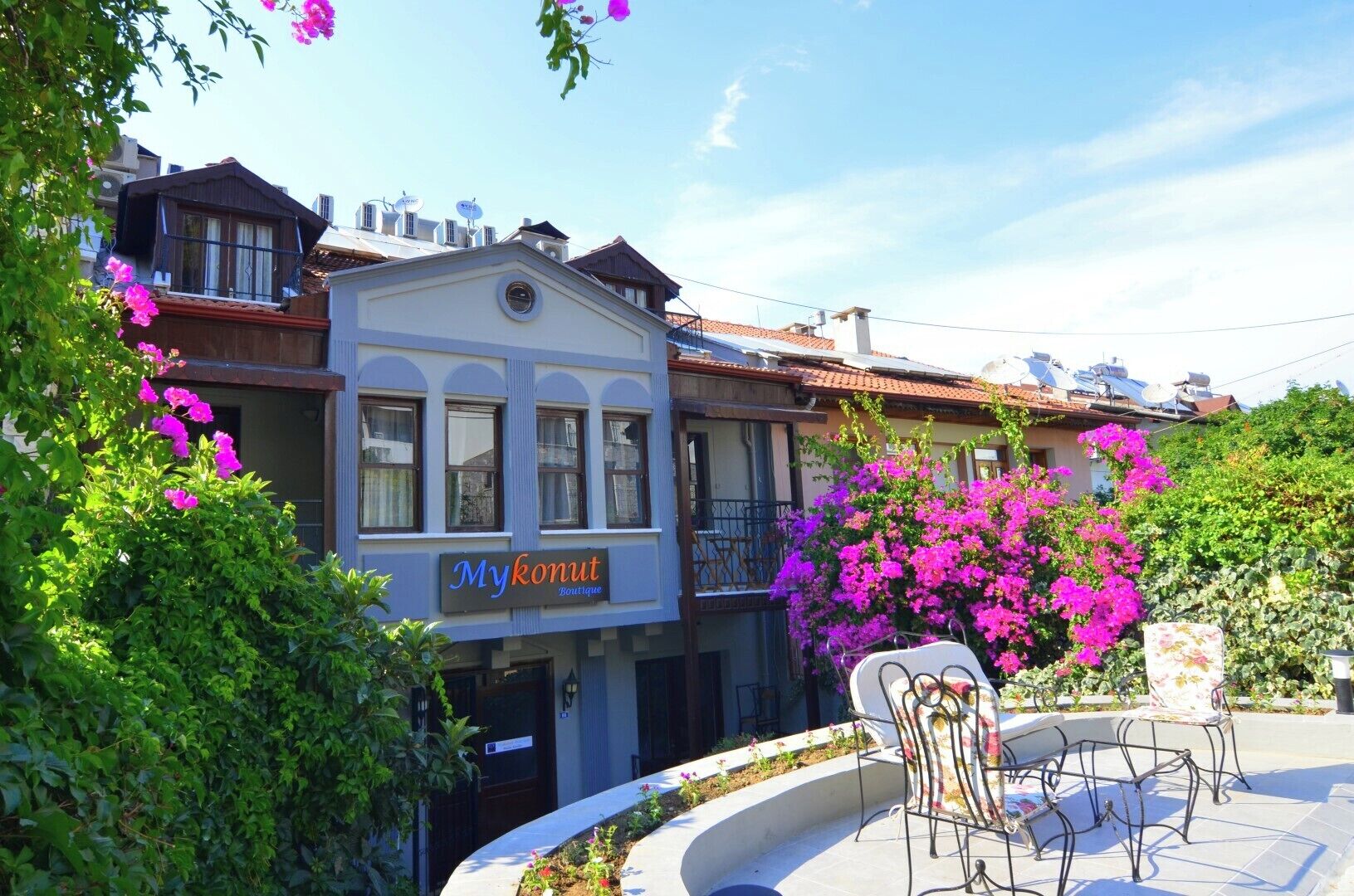 A boutique hotel with a sign reading "Mykonut Boutique."