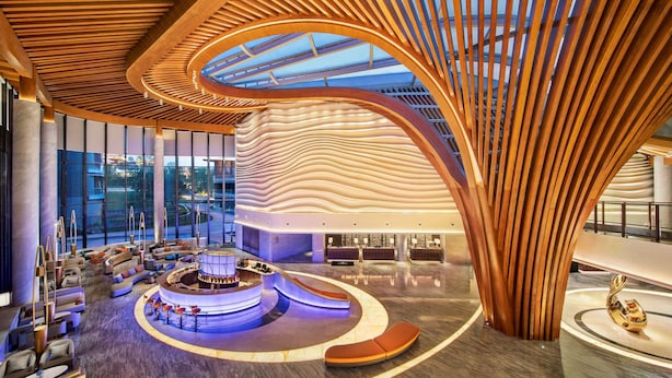 A spacious lobby with a central seating area, large windows, and a distinctive wooden ceiling structure. - Radisson Collection Resort, Nanjing (Nanjing)