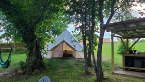A hammock, a tent, and a wooden structure with a roof. - Kings River Bell Tent Glamping  (Eureka Springs)