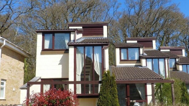 A row of modern, two-story houses with large windows and a uniform architectural style. - Villa 23 -  a house that sleeps 4 guests  in 2 bedrooms (Wootton Bridge)