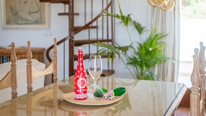 A dining table with a bottle, a wine glass, and a decorative item. - Finca with pool Ca Na Tonina in Puerto Pollensa (Puerto Pollensa)