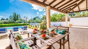 An outdoor patio with wooden furniture, a pool, and a garden view. - Finca with pool Ca Na Tonina in Puerto Pollensa (Puerto Pollensa)
