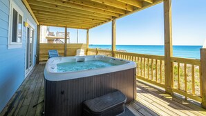 A wooden deck with a hot tub, wooden railings, and a view of the ocean. - Ocean front gem offering 6BR/5BA with direct beach access! (North Topsail Beach)