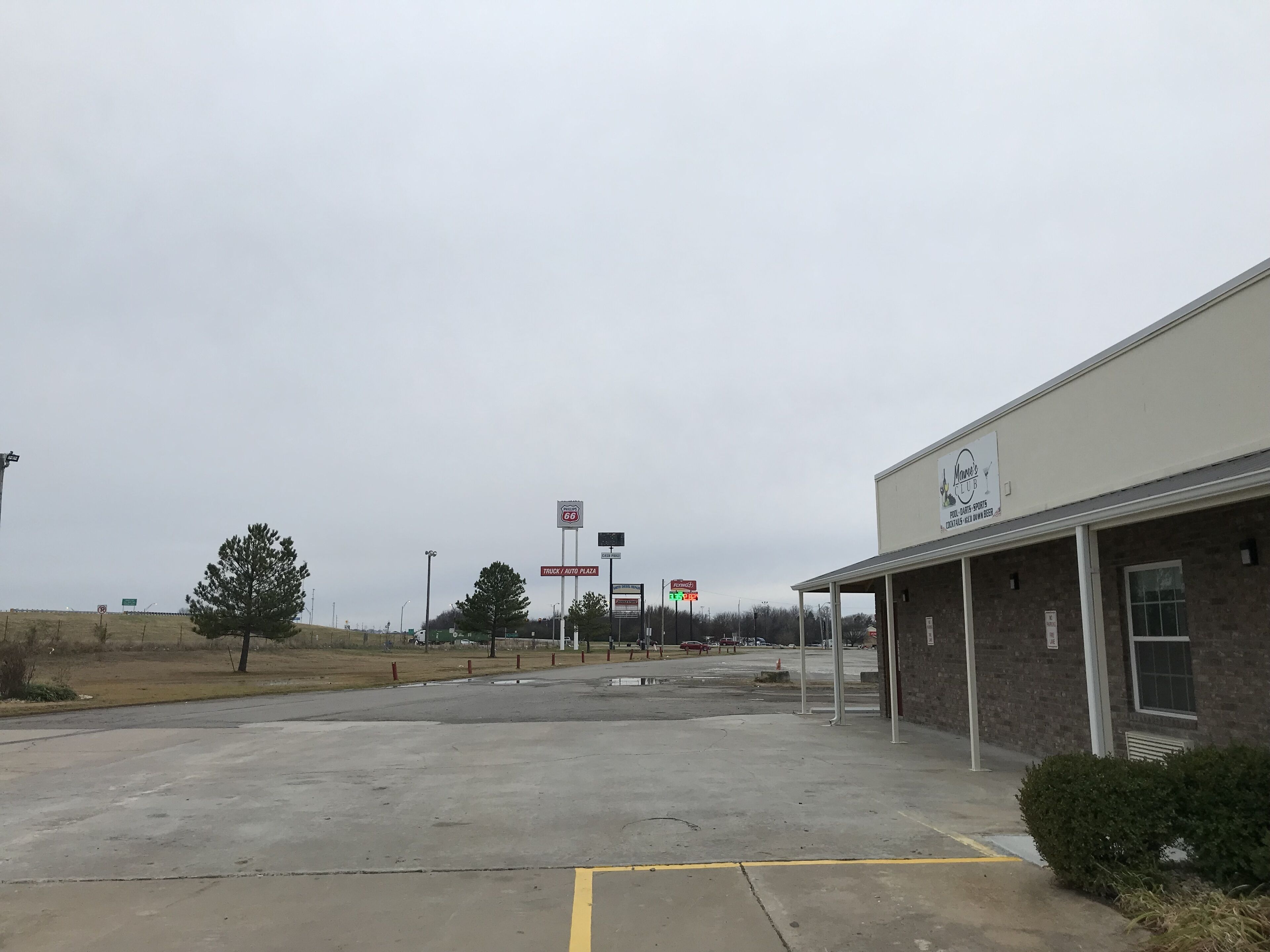 A parking lot with a building labeled "Mans Club" on the right.