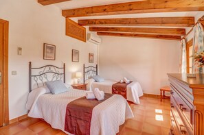 A bedroom with two beds, wooden beams on the ceiling, a dresser, and a mirror. - Johnma, Casa 5EstrellasHome Mallorca (Pollensa / Pollença)