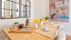 A breakfast table set with a coffee pot, a basket of snacks, a pitcher, and a fruit bowl. - Wonderful 1-bedroom apartment in Malaga center. San Agustin I (Malaga)