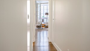 A hallway leading to a living area with a sofa, chairs, and a table. - Wonderful 1-bedroom apartment in Malaga center. San Agustin I (Malaga)