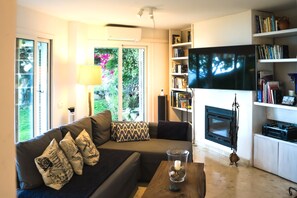 Smart TV, fireplace, books, printers