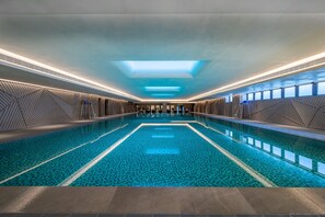 A large indoor swimming pool with geometric wall designs and skylights. - Holiday Inn Xi An Chanba (Xi'an)