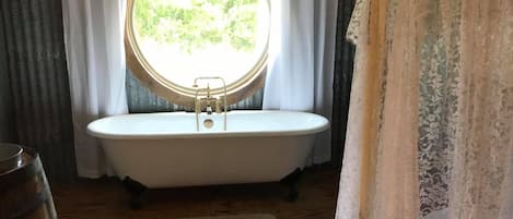 Bathtub, towels, soap, toilet paper