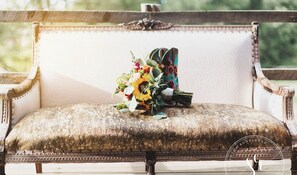 Sit on this vintage bench amidst lush greenery, surrounded by a beautiful bouquet of sunflowers.