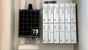 A wall-mounted air conditioning unit with a control panel and a set of numbered storage boxes. - Le Soleil Asato (Naha)