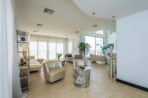 Relax in a spacious living area with a comfortable sofa, armchairs, and a unique coffee table.