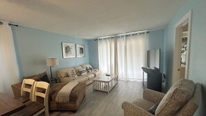 A living room with a sofa, chairs, a coffee table, and a TV. - Paradise awaits! (Sarasota)