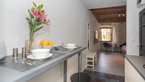 Una cocina moderna con barra, comedor y vistas al exterior.