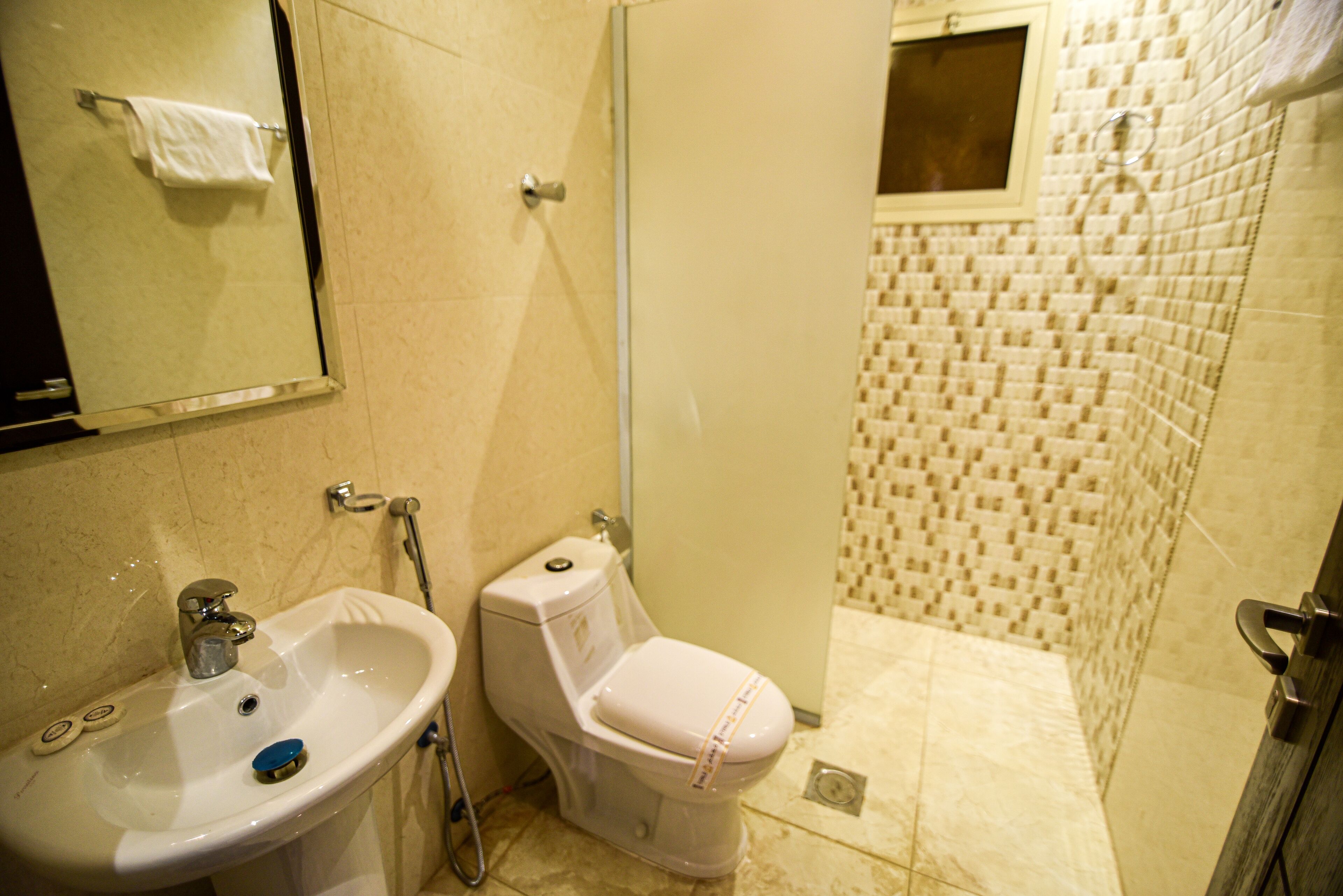 Un baño con lavamanos, inodoro y ducha.
