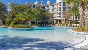 A resort with a large pool, palm trees, and a multi-story building with balconies. - Enjoy This Elegant Coastal Condo:, King-Suite,Full kitchen,Pool, Hot Tub,Balcony (Miramar Beach)