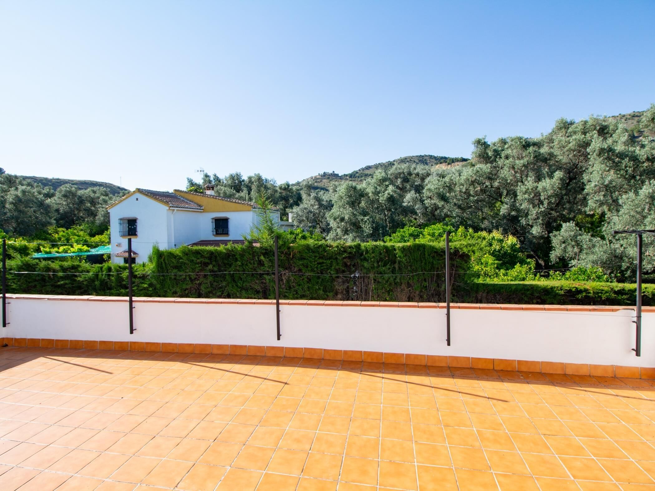 A white house with a tiled patio area.