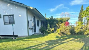 A single-story building with a flat roof, a front door, and a small porch area. - Puakenikeni Hilo Hale (Hilo)