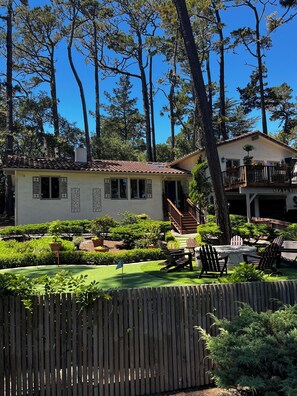 Enjoy a serene outdoor space with a beautifully maintained garden and patio area, perfect for relaxation or dining.