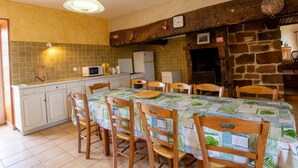 A kitchen with a tiled backsplash, wooden cabinets, a dining table with chairs, and a hanging light fixture. - Isolated house with fireplace, pets allowed, near historical sites (Villac)