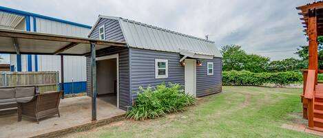 A small, single-story house with a covered porch and a well-maintained lawn.