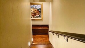 A staircase with wooden steps and a mounted deer head at the top. - Studio 57- luxury apartment in the Wapiti Area! (Cody)