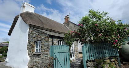 Charming Listed Thatched Cottage with parking and short walk to sandy beach .
