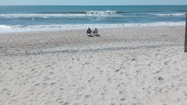 A beach with a clear sky and calm sea. - Just  a 2 minute walk to the Atlantic Ocean!
 (Surf City)