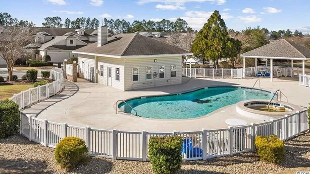 A residential property with a swimming pool, fenced deck, and a covered pavilion. - 3 Bedroom Condo in Myrtle Beach (Myrtle Beach)